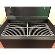 American Barbecue Systems Pit-Boss firebox interior showing expanded steel charcoal and wood grate with ash management system