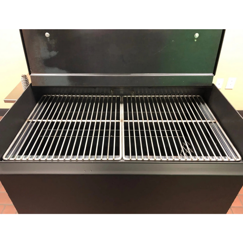 American Barbecue Systems Pit-Boss firebox interior showing expanded steel charcoal and wood grate with ash management system