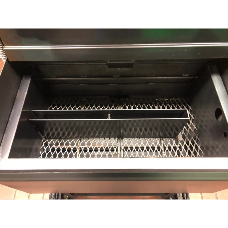 American Barbecue Systems Pit-Boss firebox top-down view showing flat steel floor and rotisserie rod mounts