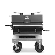 Yoder Smokers competition charcoal grill on a cart with rugged design and precision features for outdoor cooking.