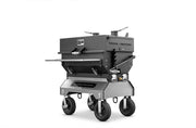 Yoder Smokers Flat Top competition charcoal grill on a wheeled cart, designed for precise outdoor cooking.