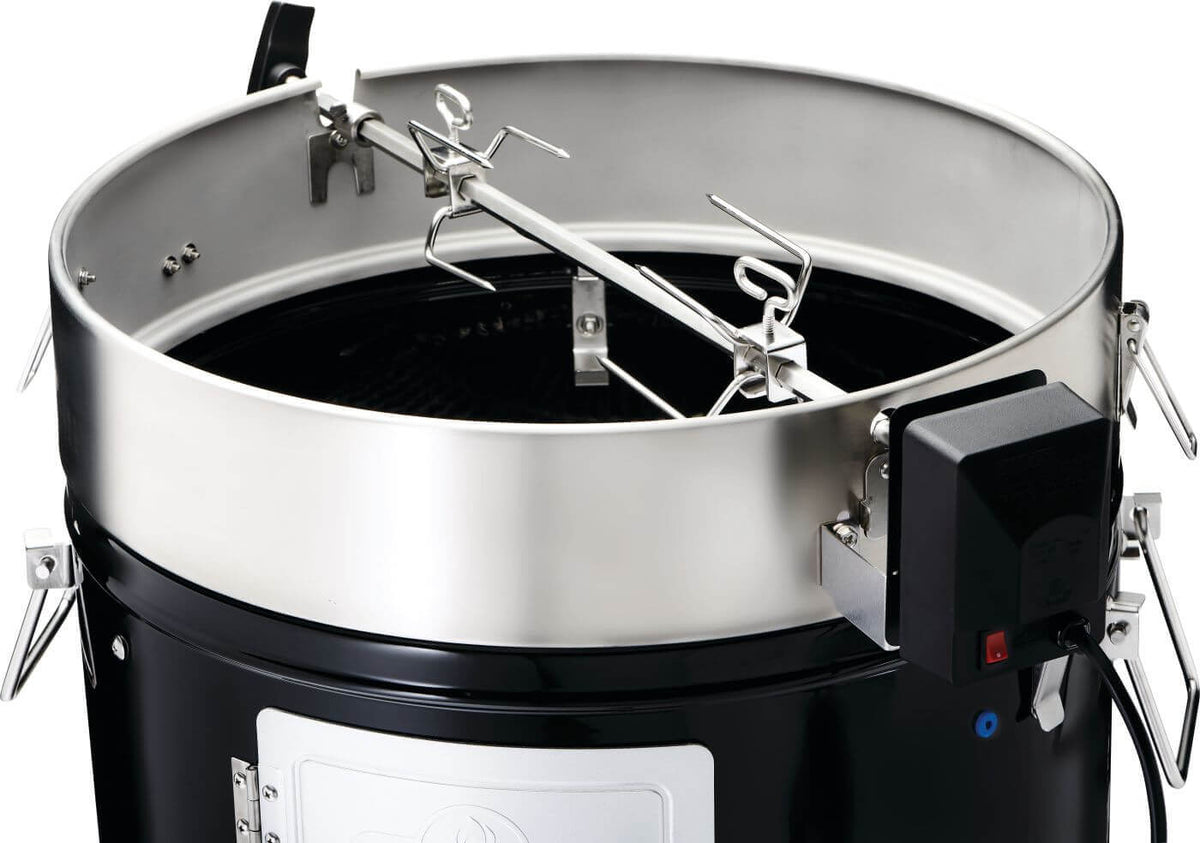 Inside view of the Napoleon Grills Apollo 18 charcoal water smoker, showcasing its stainless steel interior and adjustable features.