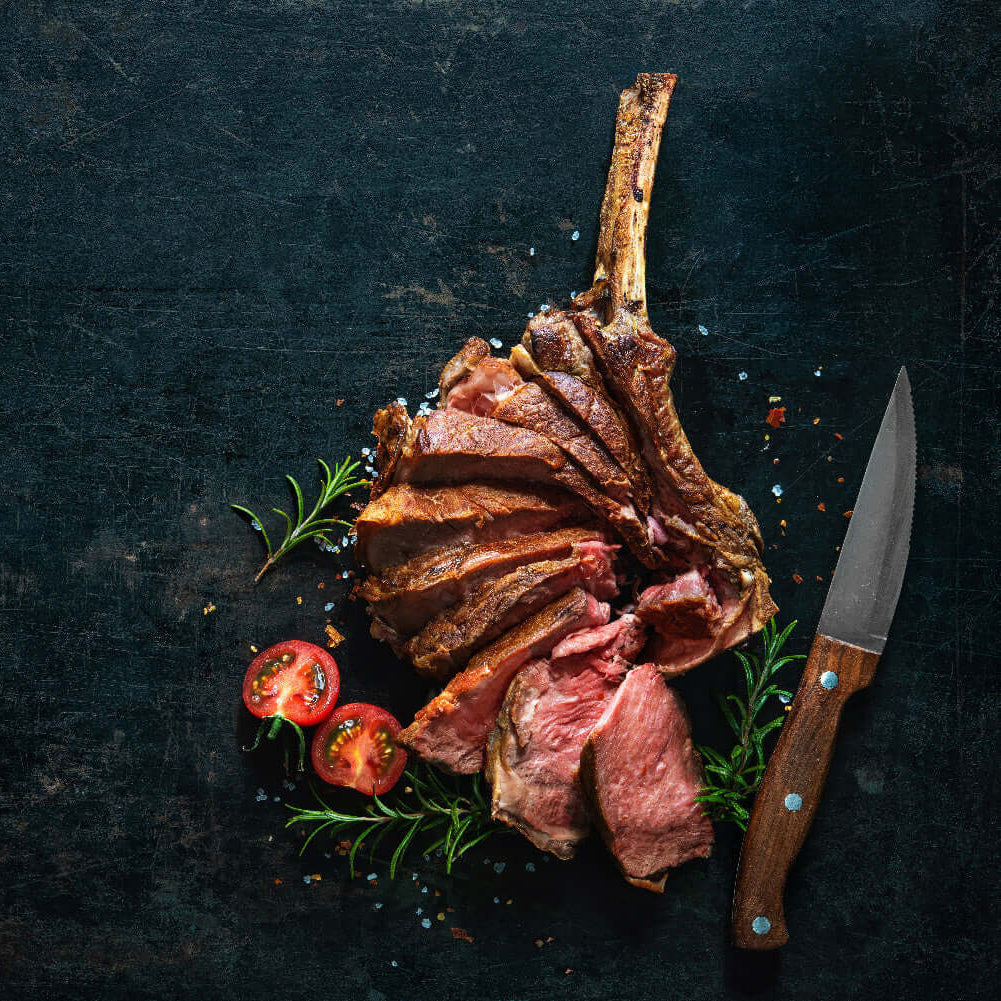 Bone-in cowboy ribeye grilled with deep char and juicy marbling