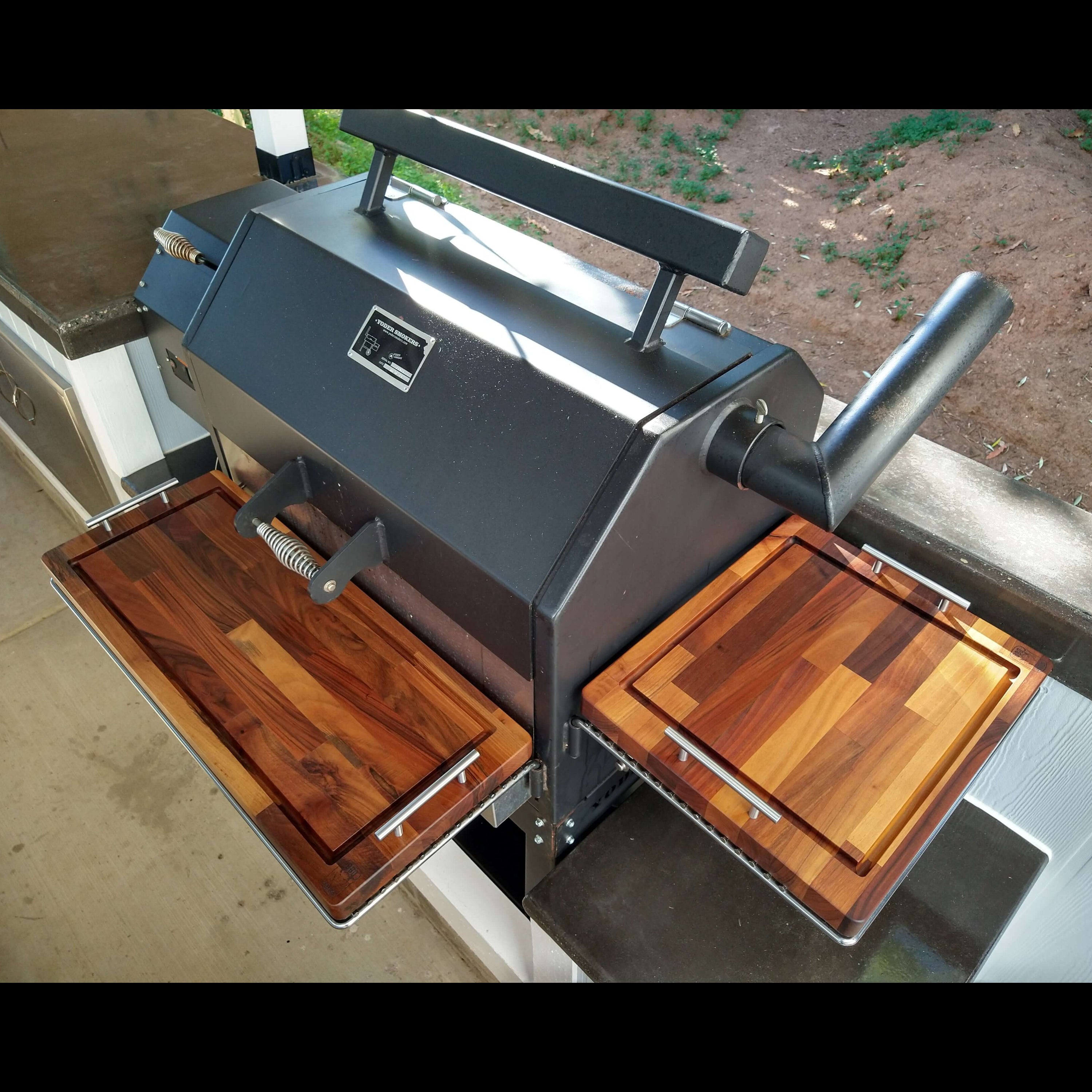 Portable grill with wooden cutting boards on a countertop