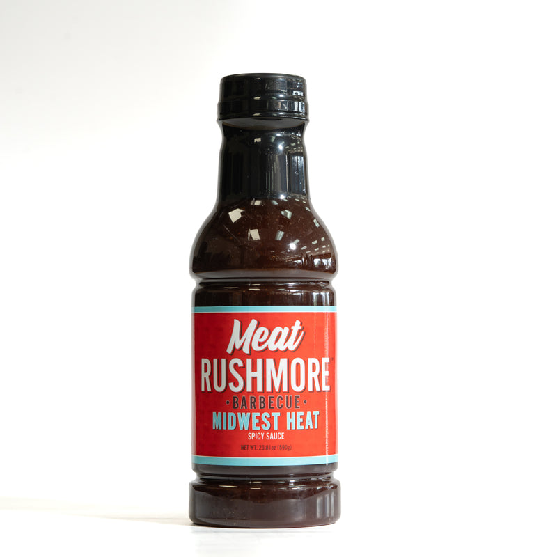 A bottle of Meat Rushmore Barbecue Midwest Heat Spicy Sauce on a clean white background.