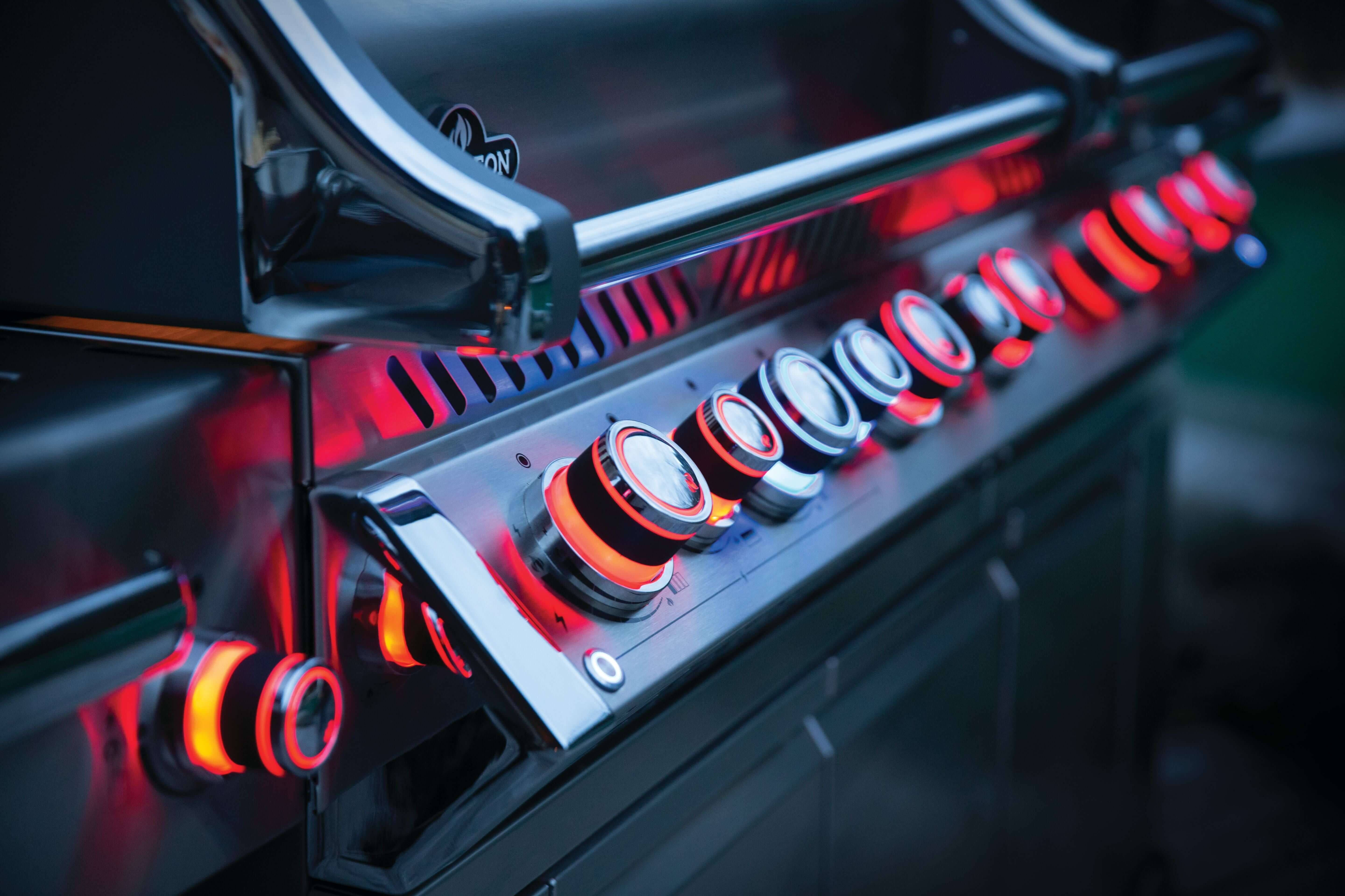 Napoleon Prestige PRO 825 gas grill controls with illuminated knobs showcasing luxury and performance.