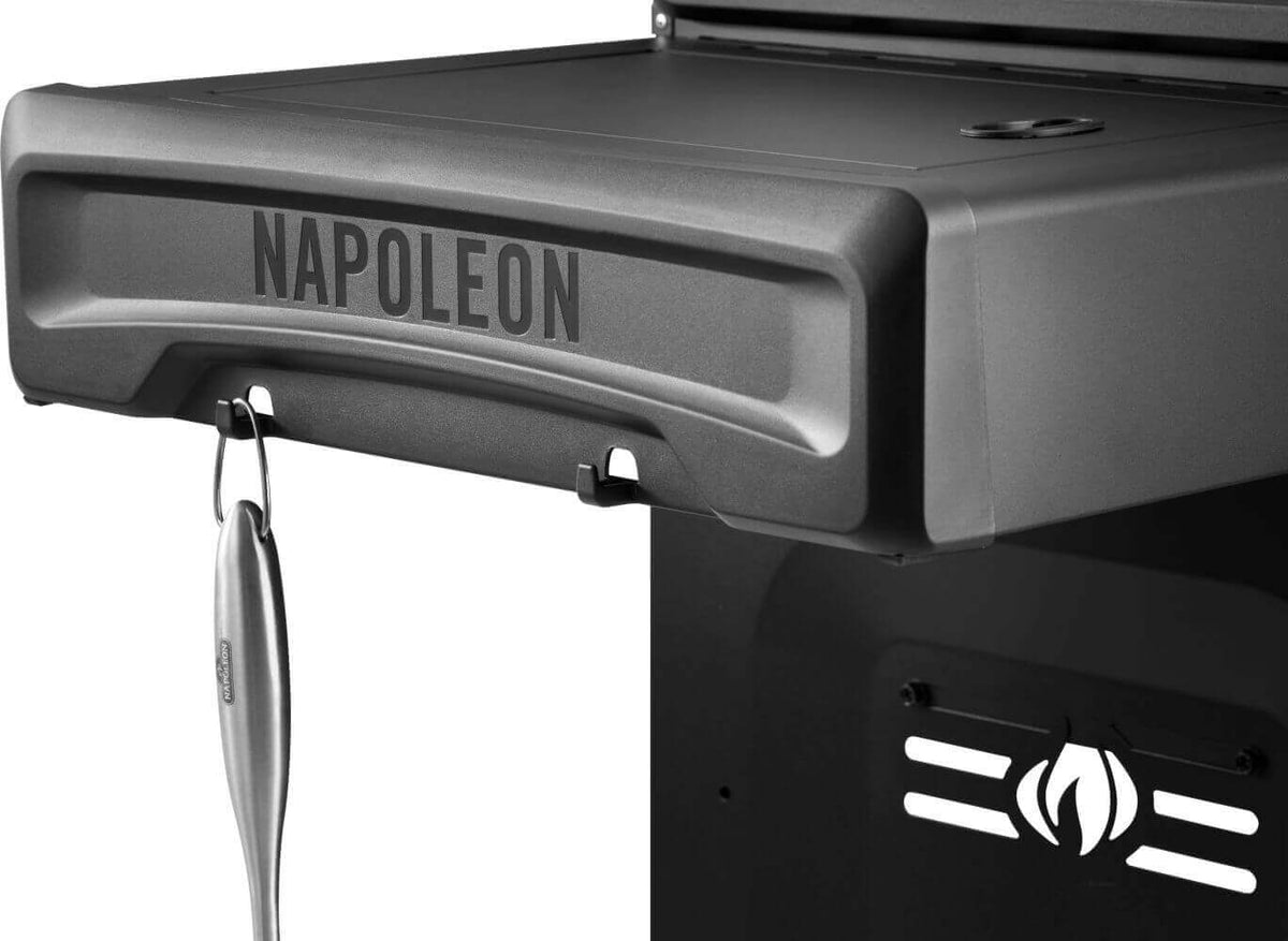 Close-up of Napoleon gas griddle with visible branding and tool holder, showcasing the durable design.