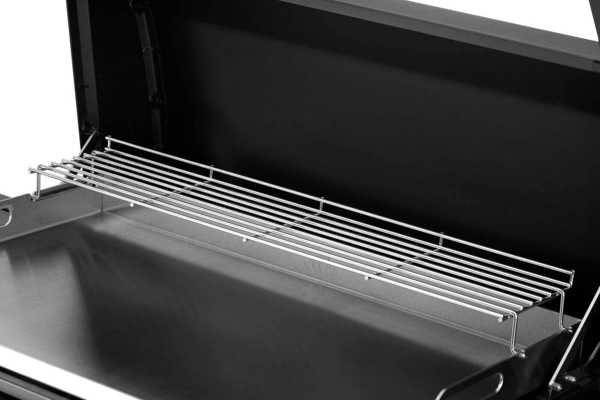 Close-up of the Napoleon gas griddle's stainless steel cooking grate inside the hood.
