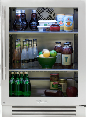 True Residential outdoor glass door undercounter refrigerator displaying drinks and condiments on glass shelves.