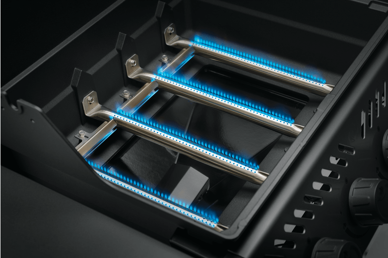 Napoleon Freestyle 425 gas grill burners with blue flame, showcasing the advanced JETFIRE ignition system.