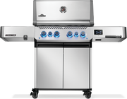 Napoleon Prestige 500 connected grill in stainless steel with lit knobs and dual doors.