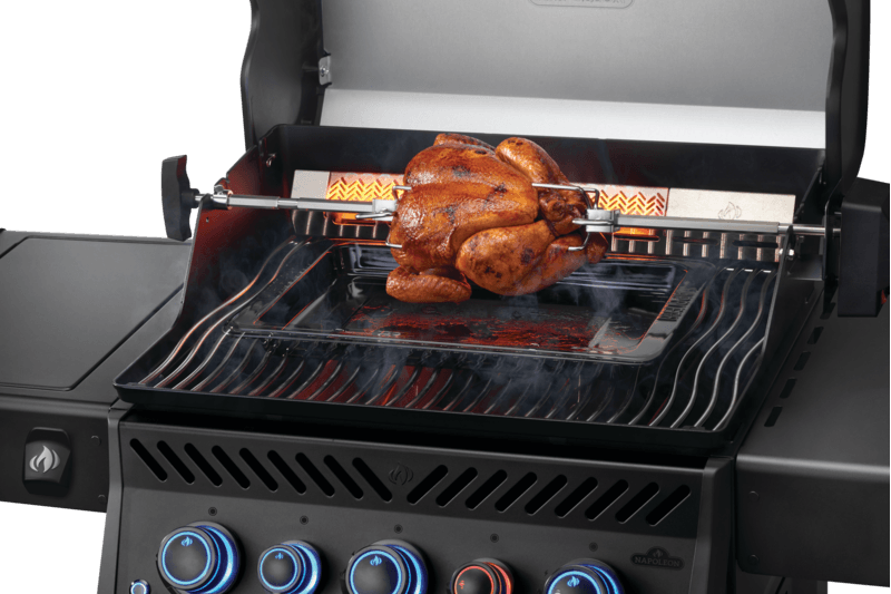 Napoleon Phantom Rogue PRO-S 425 Grill showcasing a perfectly roasted chicken on its infrared rotisserie burner.