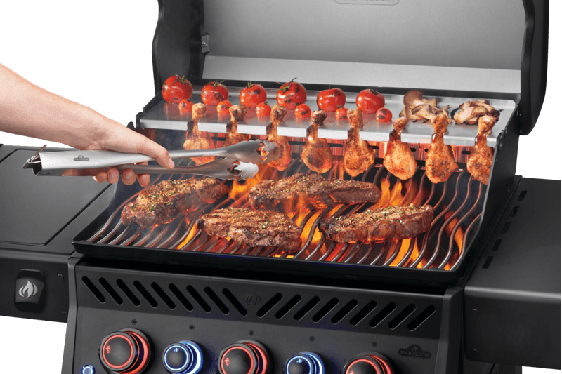 Napoleon Phantom Rogue PRO-S 425 Grill with steaks and chicken being grilled on a flame-kissed BBQ.