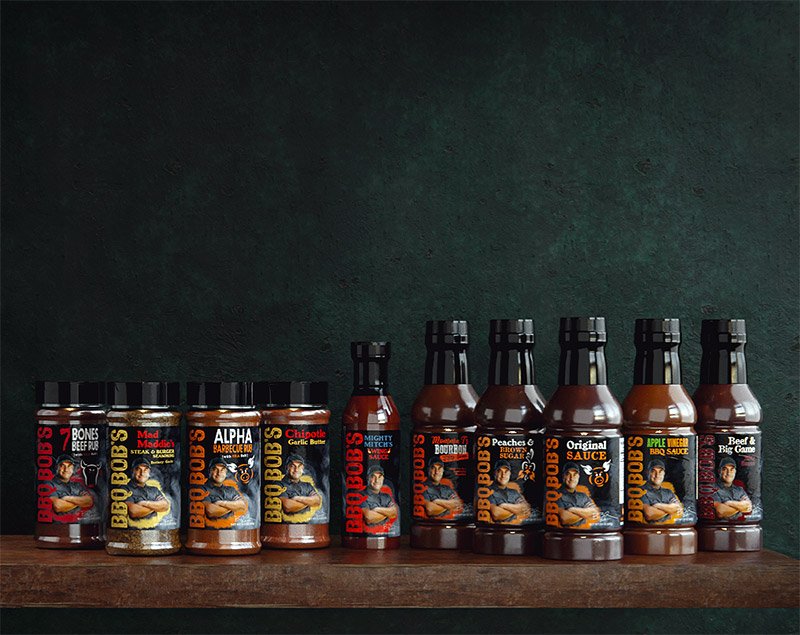 Bobby T's Mad Maddie's Steak and Burger Seasoning among other BBQ sauces and seasonings in a rustic setting.