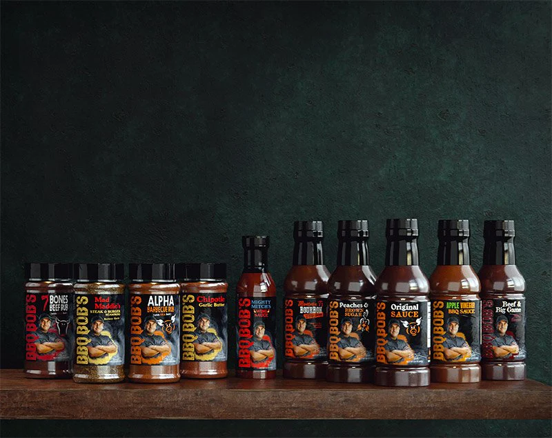 Bobby T's Chipotle Garlic Butter Seasoning and BBQ sauces on a wooden shelf, showcasing vibrant packaging and flavors.