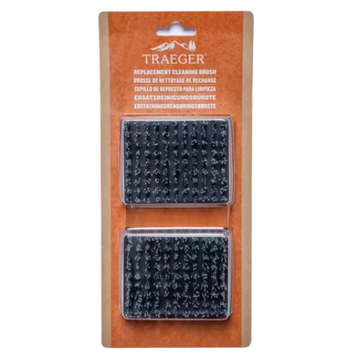 Traeger replacement cleaning brush set in its original brown cardboard blister packaging, showing two black textured brush heads.