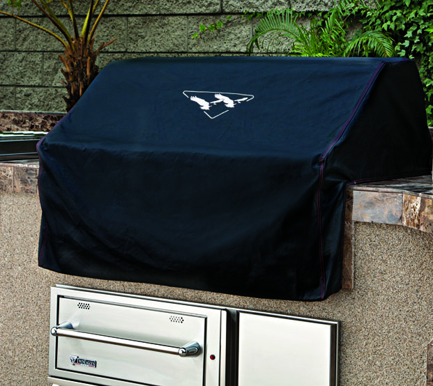 Built-in grill cover for teppanyaki protecting stainless steel grill from the elements in an outdoor kitchen.