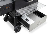 Black barbecue grill with open drawer on a white background