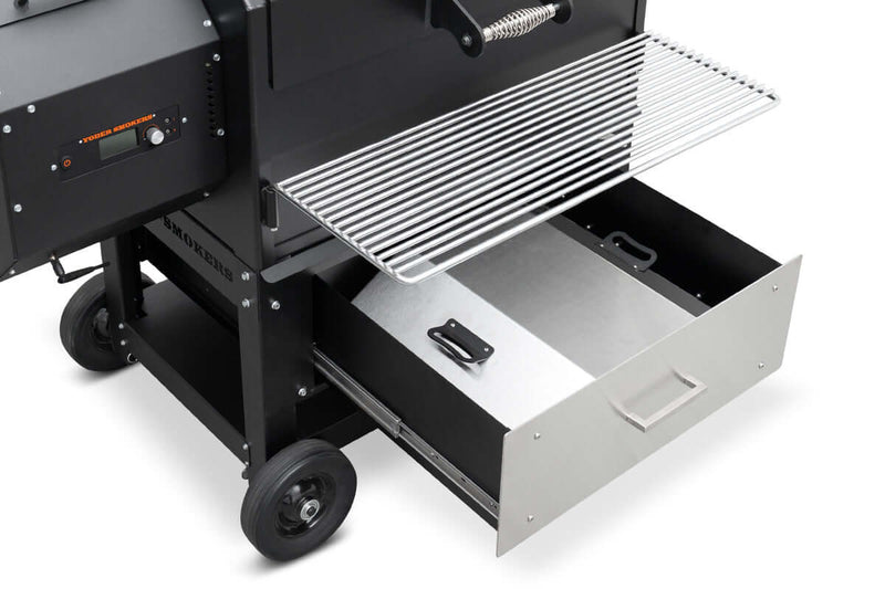 Black barbecue grill with open drawer on a white background